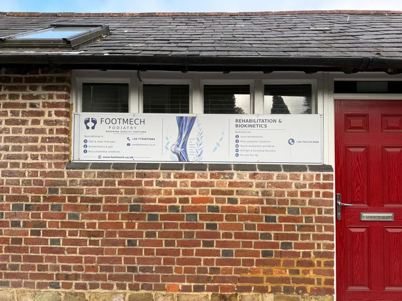 Footmech Podiatry clinic on Chart Lane, Reigate, with the Footmech sign beside the red front door